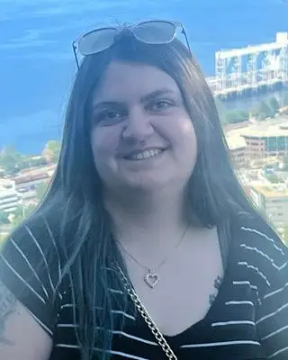 Therapist, Hope Johnson, smiling warmly to create a welcoming, safe space for clients seeking support at Wise Mind Counseling.