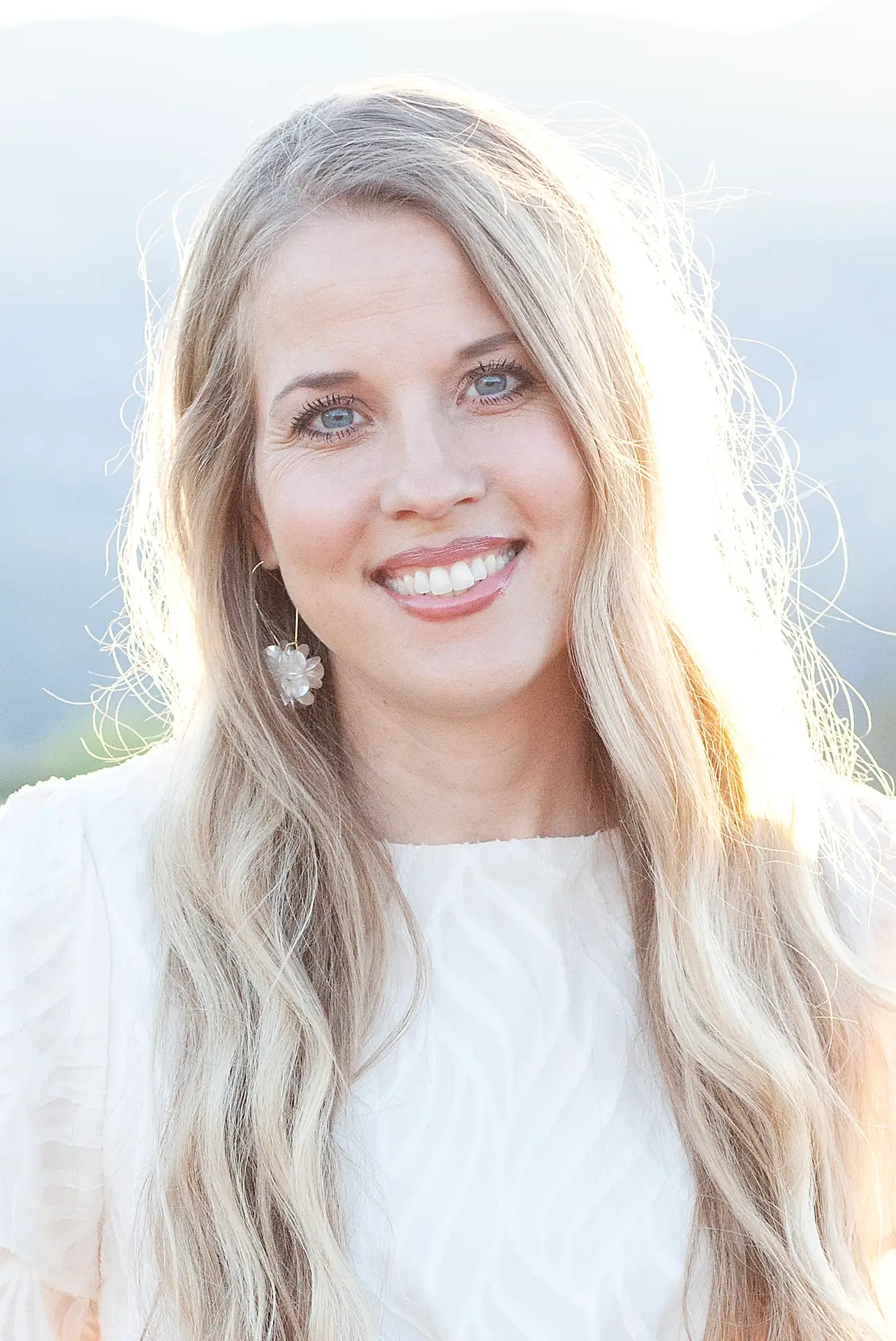 Therapist, Ramona McConkie, smiling outdoors with a warm and approachable presence, reflecting compassion and emotional support at Wise Mind Counseling.